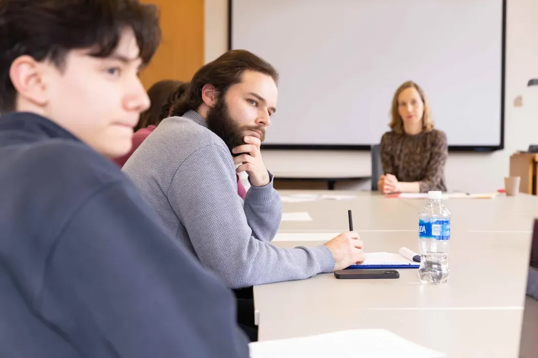 Students sitting at a table in a classroom.